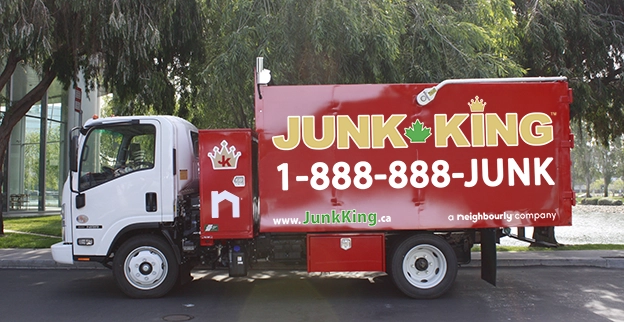 A branded Junk King dump truck parked on the street.