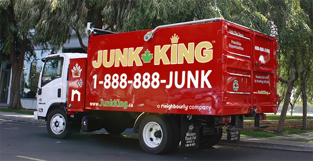A branded Junk King dump truck parked on the street.