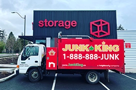 Junk King dump truck parked in front of a storage facility.