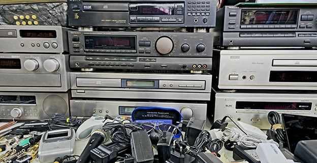 A pile of old radio receivers.