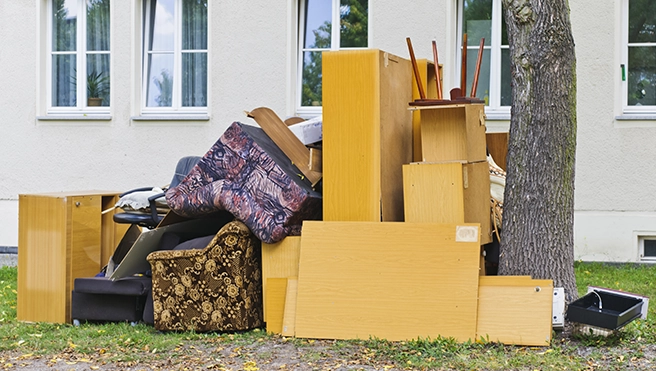 Pile of old furniture outside.