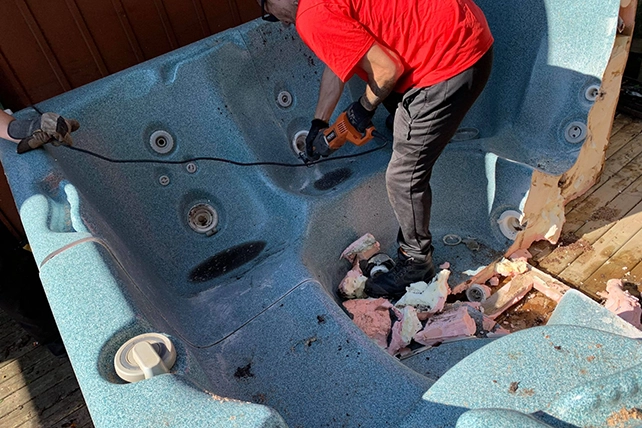 A Junk King professional removing a hot tub.