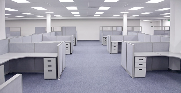 Empty office building with several cubicles.
