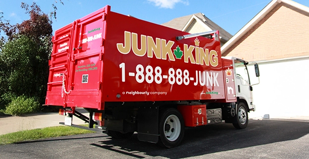 Red dump truck parked outside of a home.