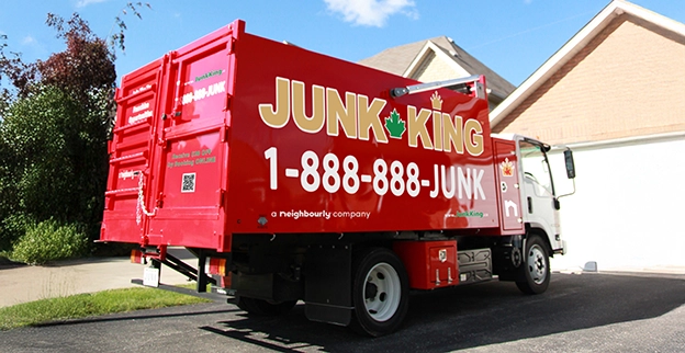 Red dump truck parked in front of a home.