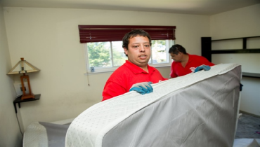 Junk King employees removing mattress